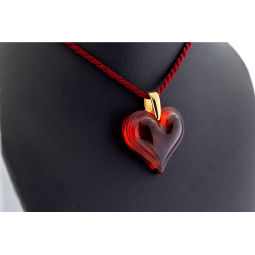 1146 - A Lalique Amoureuse Beaucoup Heart Necklace the red glass heart-shaped pendant signed to a tapered y... 