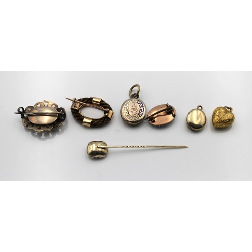 1188 - A small collection of miniature mourning jewellery to include a yellow metal stick pin with glass ha... 