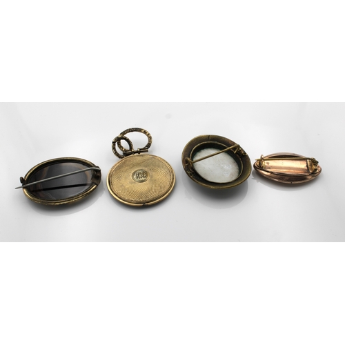 1194 - Four pieces of mourning jewellery to include a oval brooch with ceramic floral insert within a black... 