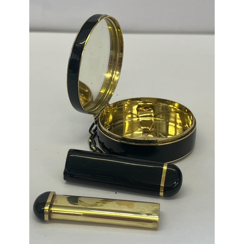 1201 - A Cartier Art Deco 18ct yellow gold and black enamel powder compact and lipstick holder the circular... 