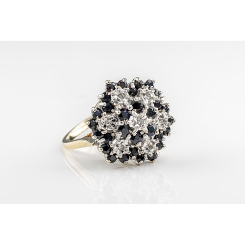 1208 - A sapphire and diamond cluster ring in 9ct yellow and white gold, the large head set with round-cut ... 