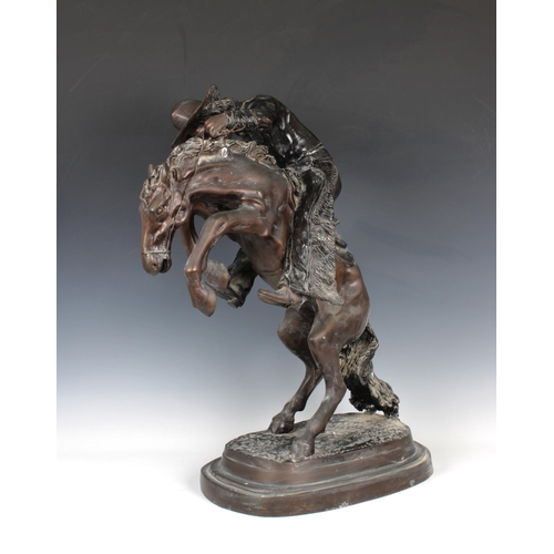 1400 - A large bronze figure of a cowboy on horseback, in the manner of Frederick Remington modelled as 'Th... 