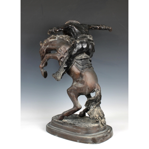 1400 - A large bronze figure of a cowboy on horseback, in the manner of Frederick Remington modelled as 'Th... 