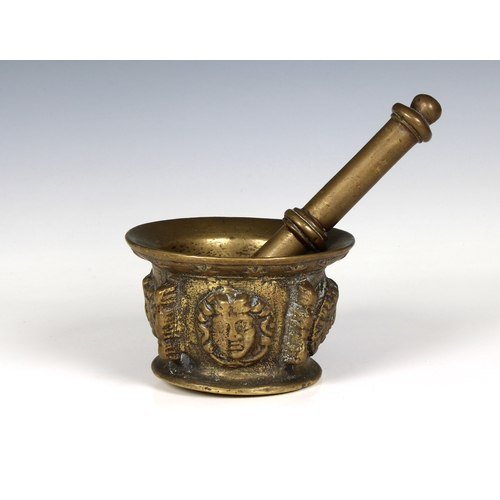 1448 - A 17th century figural brass apothecary pestle and mortar the body decorated with four classical mas... 