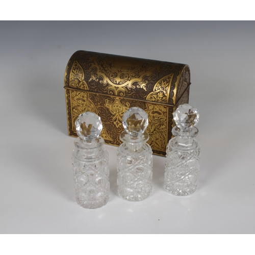 1501 - A 19th century brass inlaid decanter box containing three cut glass bottles with stoppers the domed ... 