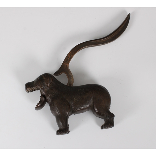 1511 - An early 20th century novelty cast iron nutcracker in the form of a dog 23cm. long.