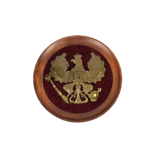 1536 - A Prussian enlisted mans pickelhaube helmet plate the plate attached to circular oak frame, maroon v... 