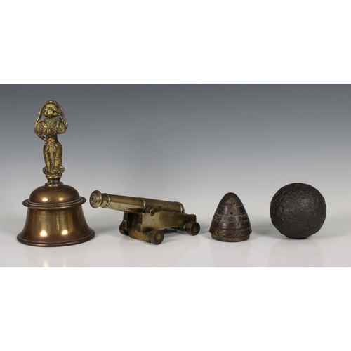 1565 - A bronze model cannon and carriage 20.3cm. long, together with a brass bell possibly fashioned from ... 