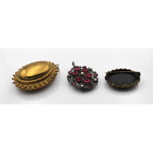 1195 - Three pieces of mourning jewellery to include an oval pinchbeck locket pendent, opening to reveal a ... 