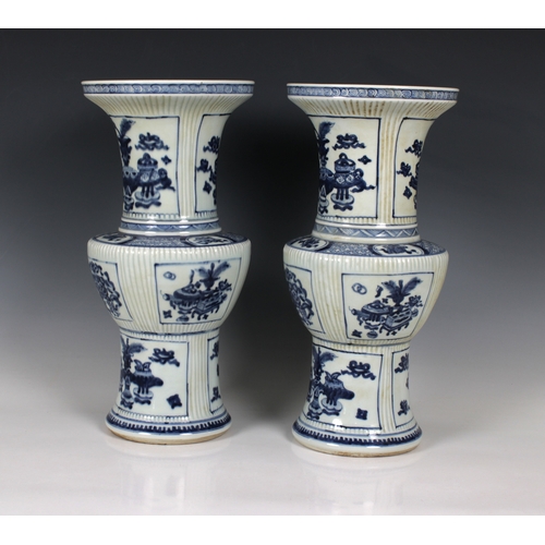 693 - A pair of early 20th century Chinese blue and white porcelain vases zun form, with incised fluted de... 