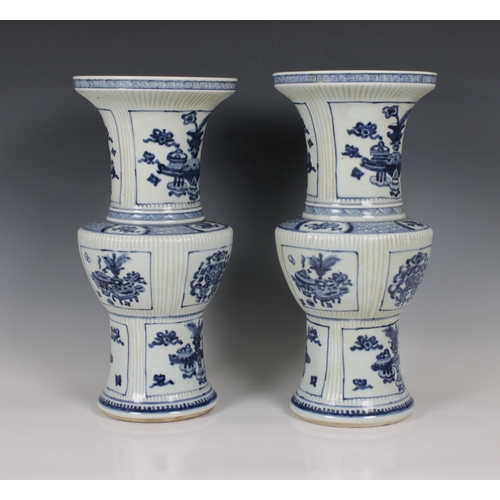 693 - A pair of early 20th century Chinese blue and white porcelain vases zun form, with incised fluted de... 