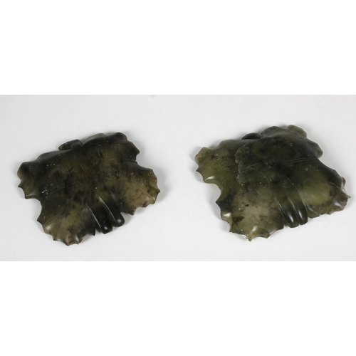 697 - A pair of Chinese spinach jade pin dishes of shaped square leaf form, 9.6cm. square. (2)