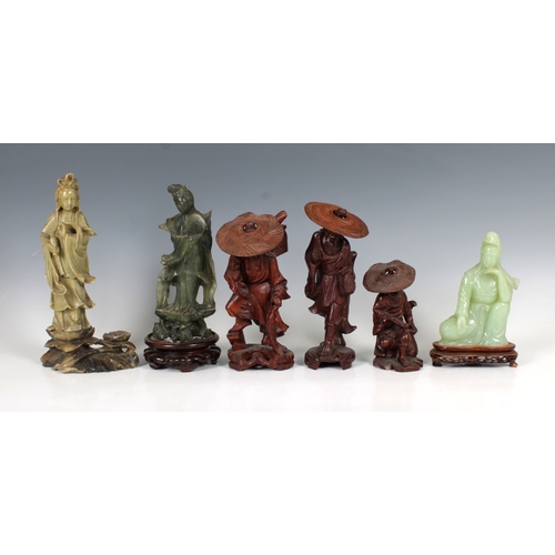 698 - A collection of various Oriental figures etc to include carved green stone figures, wooden figures, ... 