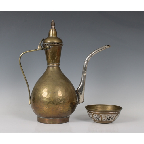 709 - A Middle Eastern brass ewer 35cm. high, together with a small mixed metal Damascus type bowl, 12.7cm... 