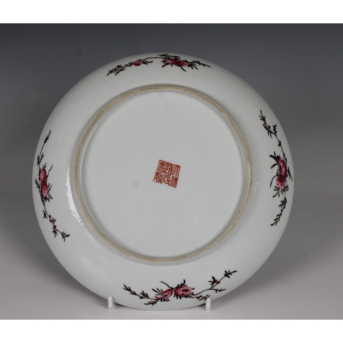 731 - A Chinese famille rose enamelled dish the interior of the shallow bowl painted with exotic birds at ... 