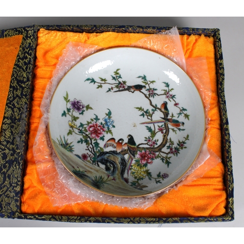 731 - A Chinese famille rose enamelled dish the interior of the shallow bowl painted with exotic birds at ... 