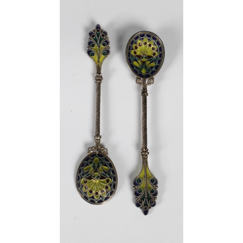 1023 - **WITHDRAWN**
A set of six ornate white metal and enamel teaspoons on stand indistinct marks, probab... 