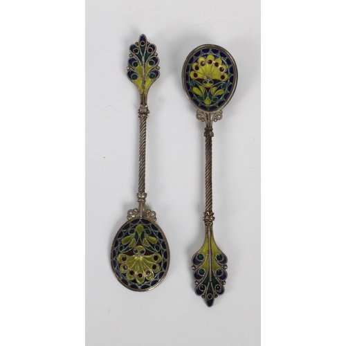 1023 - **WITHDRAWN**
A set of six ornate white metal and enamel teaspoons on stand indistinct marks, probab... 