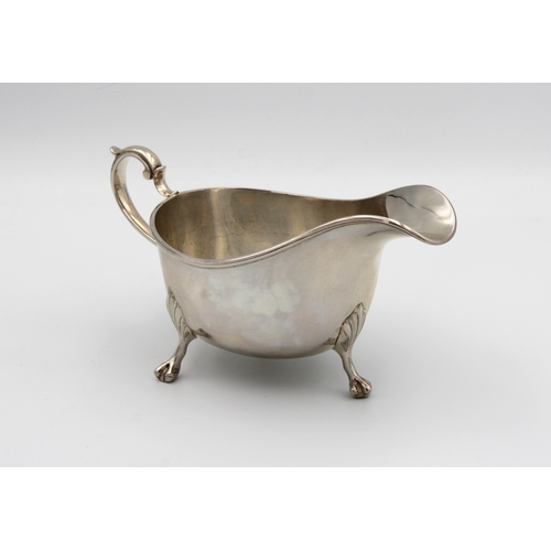 1024 - A silver sauce boat Indistinct maker's mark, London, 1915, of typical plain form with scroll handle,... 