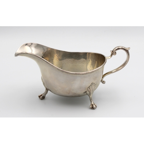 1024 - A silver sauce boat Indistinct maker's mark, London, 1915, of typical plain form with scroll handle,... 