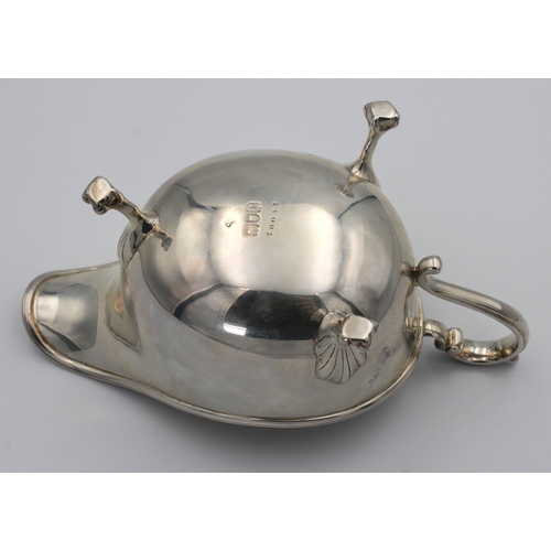 1024 - A silver sauce boat Indistinct maker's mark, London, 1915, of typical plain form with scroll handle,... 