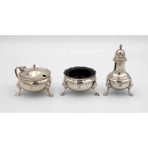 1029 - A silver cruet set Harrods Ltd, London, 1957, of cauldron form, comprising of mustard, open salt wit... 