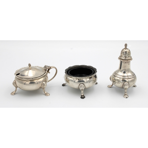 1029 - A silver cruet set Harrods Ltd, London, 1957, of cauldron form, comprising of mustard, open salt wit... 