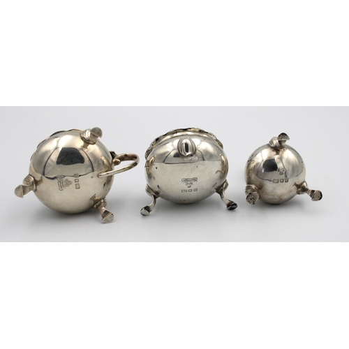 1029 - A silver cruet set Harrods Ltd, London, 1957, of cauldron form, comprising of mustard, open salt wit... 