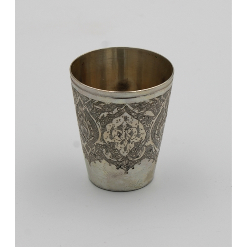 1031 - A Persian / Iranian silver tot cup marked 'VARTAN', of typical form with intricate decoration, 4.6cm... 