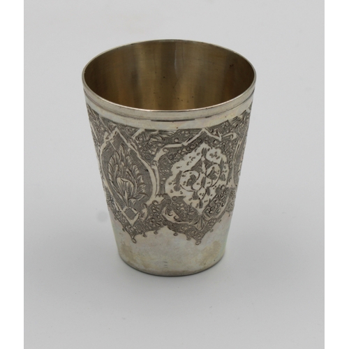 1031 - A Persian / Iranian silver tot cup marked 'VARTAN', of typical form with intricate decoration, 4.6cm... 