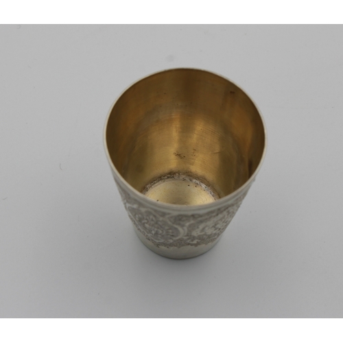 1031 - A Persian / Iranian silver tot cup marked 'VARTAN', of typical form with intricate decoration, 4.6cm... 