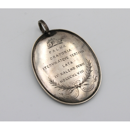 1037 - A large 19th century white metal presentation oval pendent roughly translated 'WILLIAM CHESSBOROUGH ... 