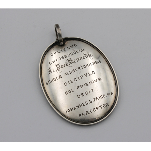 1037 - A large 19th century white metal presentation oval pendent roughly translated 'WILLIAM CHESSBOROUGH ... 