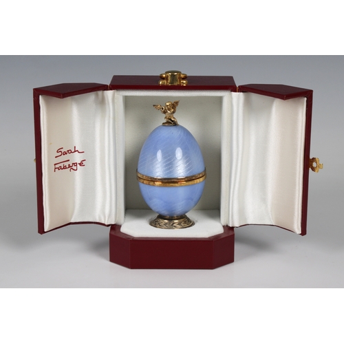 1038 - **WITHDRAWN**
A cased Sarah Faberge silver gilt and blue enamelled surprise egg the detachable top s... 