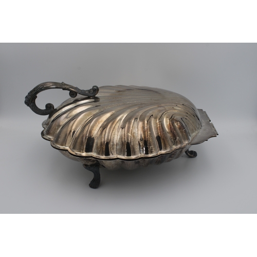 1043 - A large silver plate scallop shell warming dish probably by the Sheffield silver Company, United Sta... 