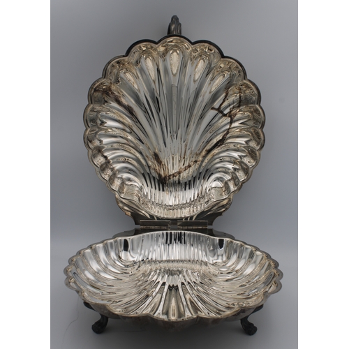 1043 - A large silver plate scallop shell warming dish probably by the Sheffield silver Company, United Sta... 