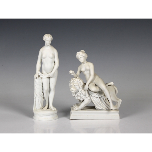 23 - Two late 19th century Parian Ware figures of female nudes one seated on a lion, the other standing, ... 