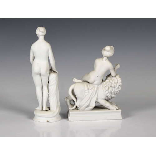 23 - Two late 19th century Parian Ware figures of female nudes one seated on a lion, the other standing, ... 