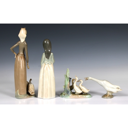 36 - A group of four Nao and Lladro figures Including girl with geese, the largest 28cm. high (4)