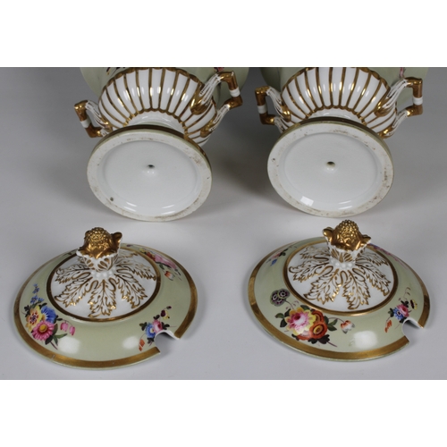 39 - A pair of porcelain campana urn form sauce tureens and covers having hand painted flower sprays on p... 