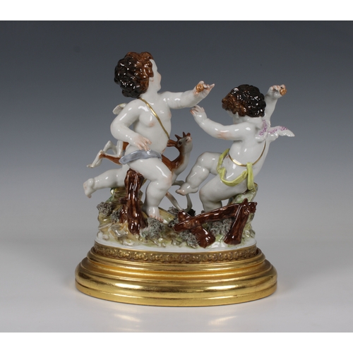 42 - A late 20th century Algora, Spain, porcelain group of a pair of cherubs with a deer on an oval giltw... 