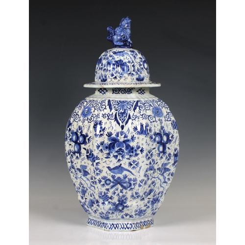 45 - An early 20th century Royal Delft style blue and white octagonal ribbed jar & cover of baluster form... 