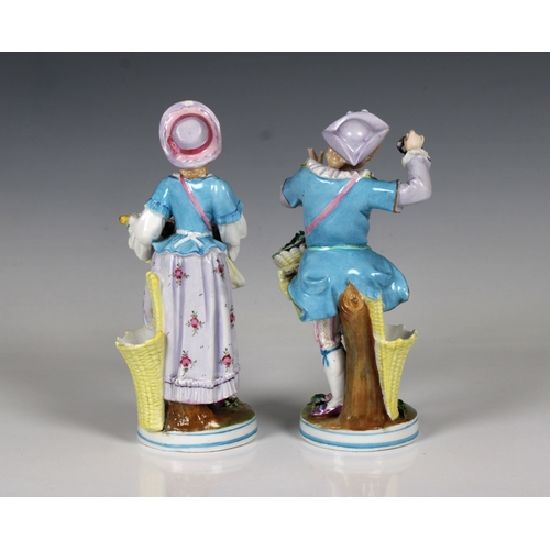 53 - A pair of 20th century Contental porcelain figures of a young elegantly dressed couple with baskets ... 