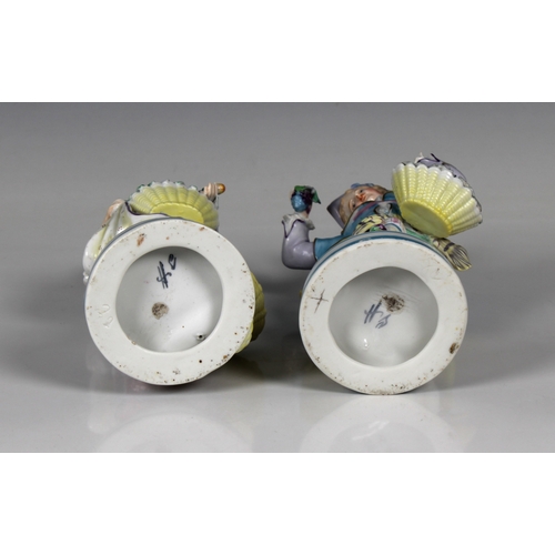 53 - A pair of 20th century Contental porcelain figures of a young elegantly dressed couple with baskets ... 