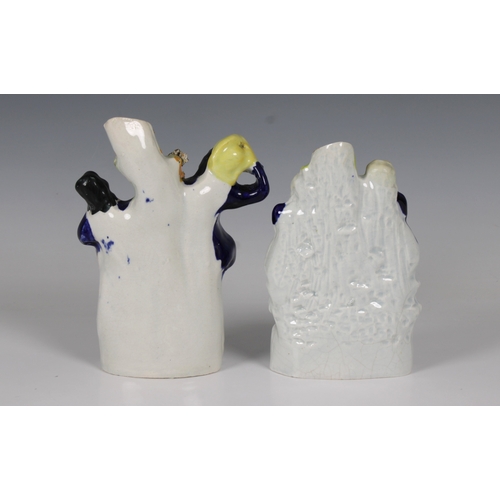 56 - Two 19th century Staffordshire ceramic spill vases each formed of two figures 17.1cm. tallest.