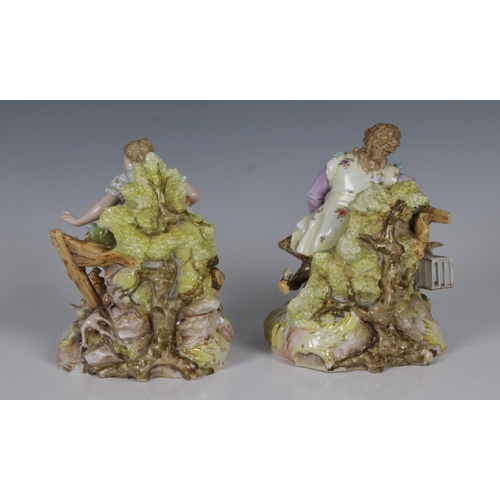 59 - A pair of Volkstedt, Germany, porcelain figures of a young elegantly dressed couple seated, the man ... 