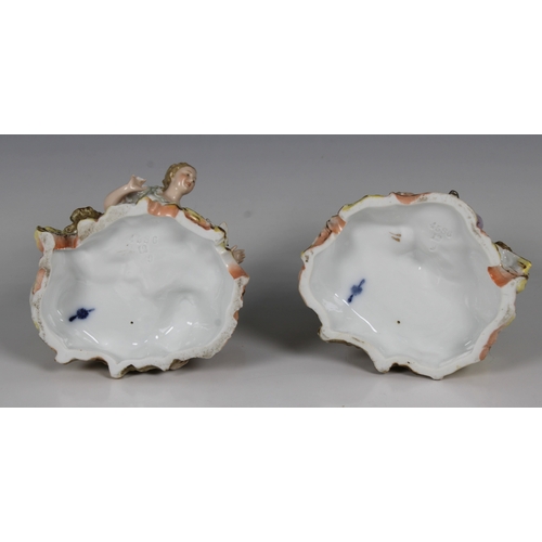 59 - A pair of Volkstedt, Germany, porcelain figures of a young elegantly dressed couple seated, the man ... 