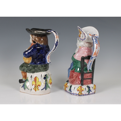 63 - A pair of Falaise ceramic figural jugs of a man playing the bag pipes and a woman, the woman marked ... 