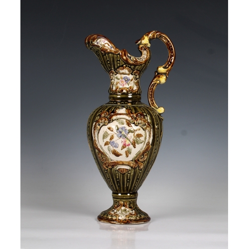 70 - A 19th Century Alhambrian type majolica ewer the green ground decorated with floral sprays, 34.5cm h... 