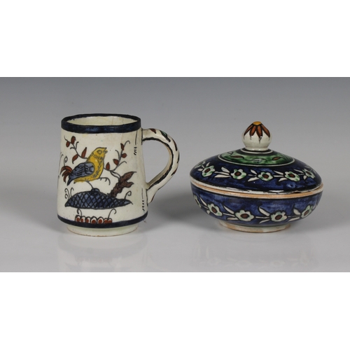 74 - Two pieces of Palestine pottery to include a circular box and cover with foliate decoration painted ... 